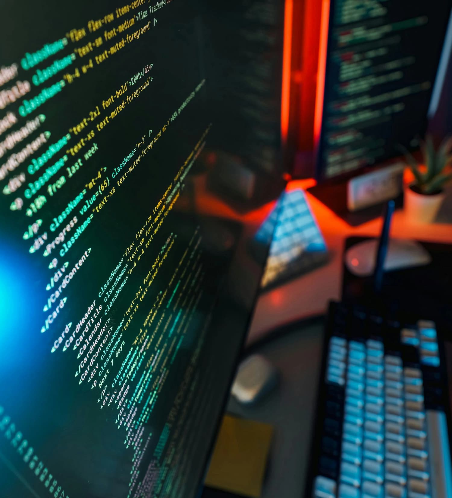 Computer on a desk showing a website being built with code on the screen